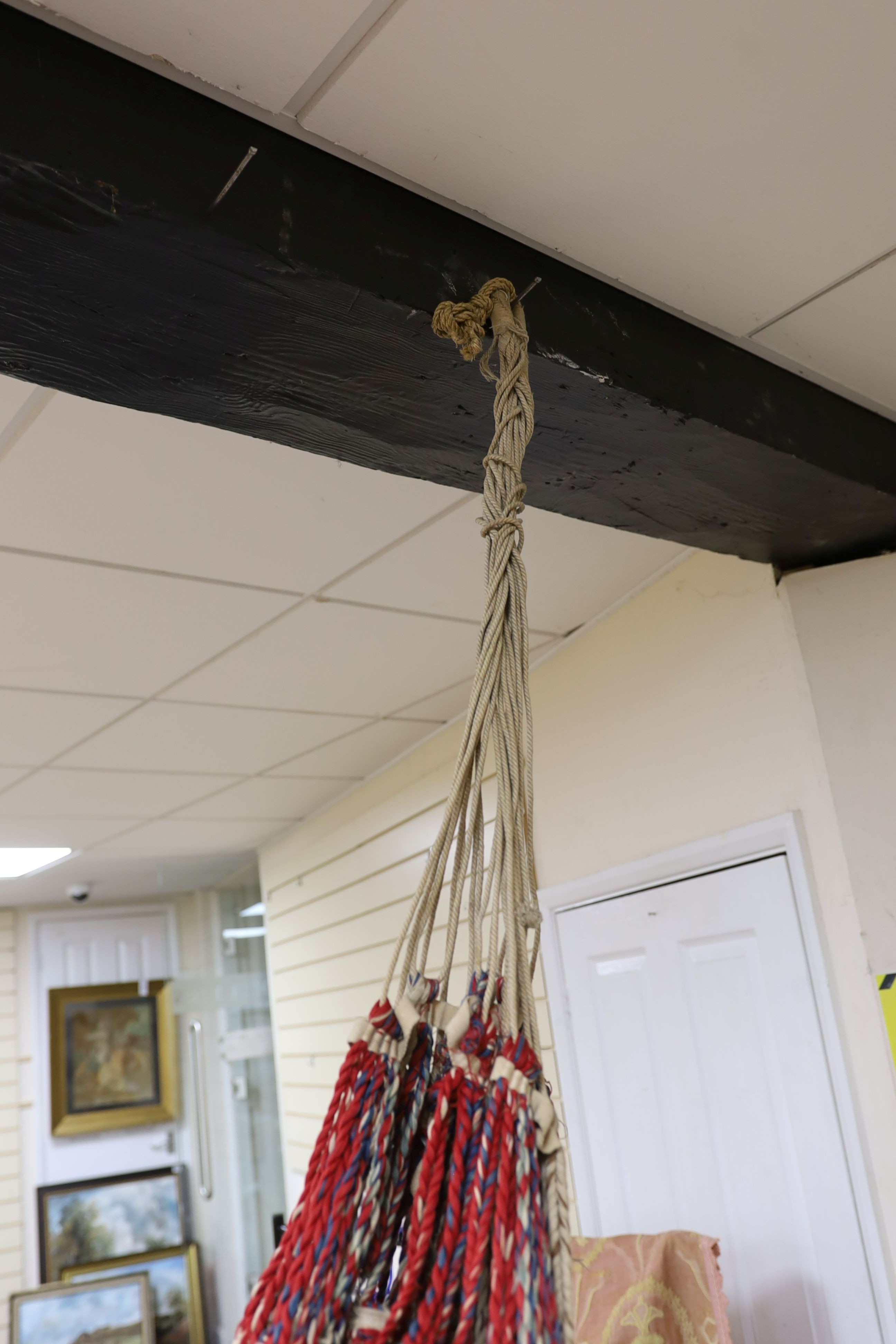 An unusual early 20th century hammock and pink brocade curtains